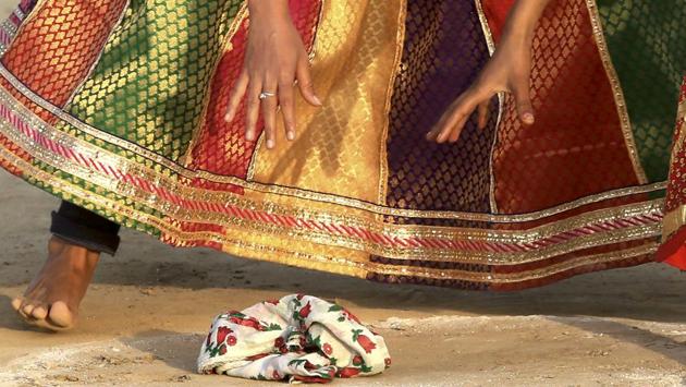 Rival teams in Rumal-Jhapatta consist of 7-10 members on both sides, standing in line 10 metres from a handkerchief kept in a circle of a diameter of approximately 1 meter. As the referee calls two players from both sides, they rush and try to pick up the handkerchief and run back towards their line before their rival player tries to catch them and score a point. (Himanshu Vyas/ht photo)