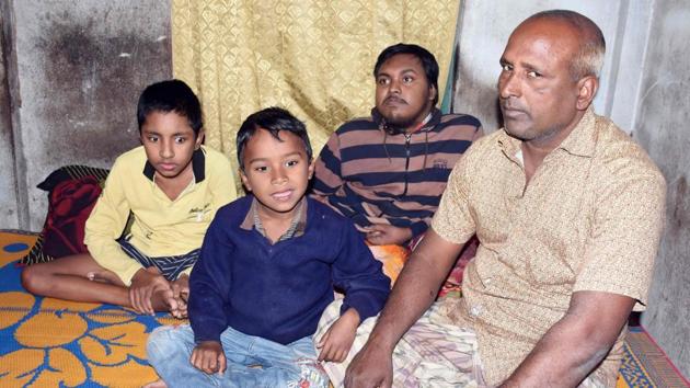 In this photograph taken on January 20, 2017, Bangladeshi father and fruit vendor Tofazzal Hossain (R), who has sparked a debate over assisted suicide, is seen with his two sons and grandson (2nd L) in Meherpur. (AFP Photo)(HT) In this photograph taken on January 20, 2017, Bangladeshi father and fruit vendor Tofazzal Hossain (R), who has sparked a debate over assisted suicide, is seen with his two sons and grandson (2nd L) in Meherpur. (AFP Photo)(HT)