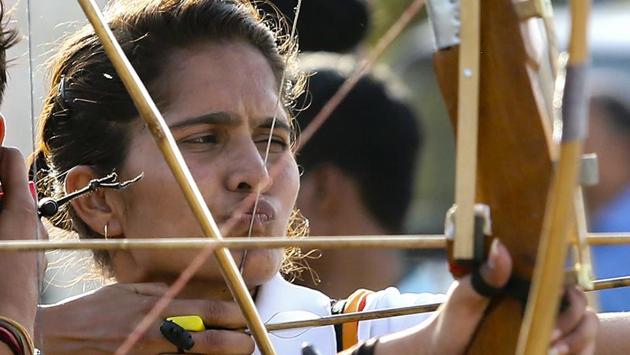 A female archer takes aim as she concentrates on the target in an archery competition at the games. (Himanshu Vyas/ht photo)