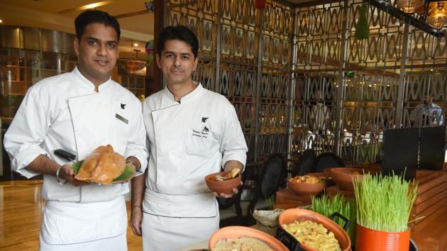 Executive chef Naveen Handa (right) with sous-chef de cuisine Ashish Kumar presenting scrumptious delicacies for the Baisakhi food festival.(Sanjeeb Sharma/HT Photo)