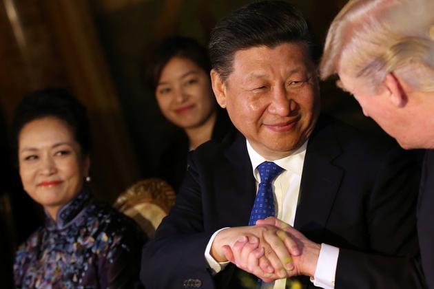 Chinese President Xi Jinping shakes hands with U.S. President Donald Trump as he is accompanied by China's first lady Peng Liyuan during a dinner at the start of a summit. The most urgent problem facing Trump and Xi is how to persuade nuclear-armed North Korea to halt unpredictable behaviour like missile test launches that have heightened tensions in South Korea and Japan. (Carlos Barria/REUTERS)