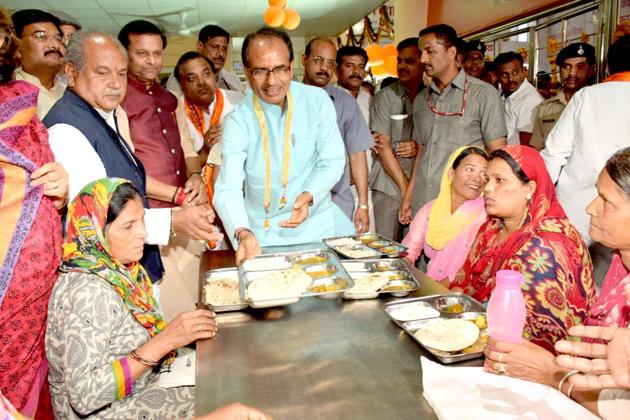 Bhopal, India - April 7, 2017: Madhya Pradesh chief minister Shivraj Singh Chouhan serving food during launch of Deendayal Rasoi yojna in Gwalior, India, on Friday, April 7, 2017. Mujeeb Faruqui Bhopal, India - April 7, 2017: Madhya Pradesh chief minister Shivraj Singh Chouhan serving food during launch of Deendayal Rasoi yojna in Gwalior, India, on Friday, April 7, 2017. Mujeeb Faruqui