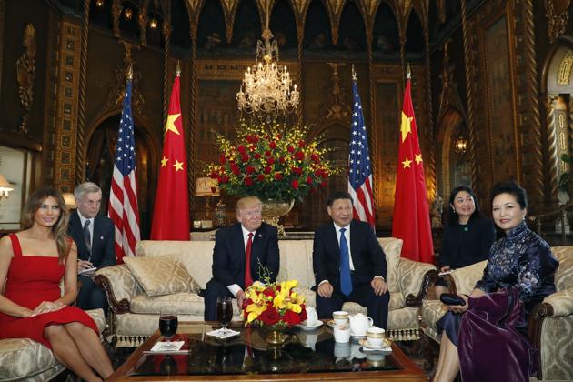 President Donald Trump and Chinese President Xi Jinping, sit with their wives, first lady Melania Trump (L) and Chinese first lady Peng Liyuan (R). Trump has threatened to use trade to try to force China to exert influence over Pyongyang. (Alex Brandon/AP)
