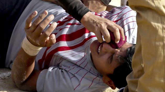 A teammate offers first aid to an injured player in the middle of a Kabaddi match. (Himanshu Vyas/ht photo)