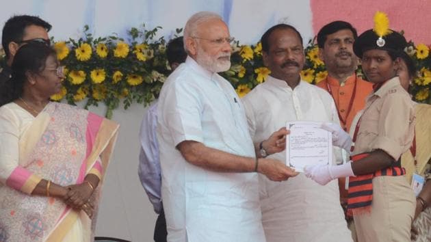 Prime Minister Narendra Modi distributing appointment letter to member of Primitive tribal battalion at programme in Sahebganj on Thursday(Bijay/ Hindustan Times)