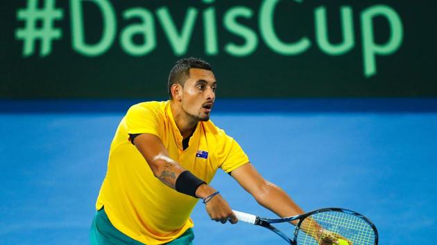 Nick Kyrgios of Australia serves to John Isner of the US during the Davis Cup World Group quarterfinal at the Pat Rafter Arena in Brisbane on Friday.(AFP)