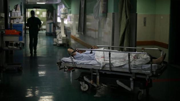 Eizz al-Deen Habash, 39, lies on a bed before his ankle surgery at Shifa hospital, Gaza's largest public medical facility, in Gaza City. But Israel tightly restricts Palestinian passage from the Gaza Strip. (Mohammed Salem/REUTERS)