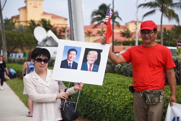 Supporters demonstrate outside the hotel where Chinese President Xi Jinping and his wife Peng Liyuan are staying. Trump promised during the 2016 presidential campaign to stop what he called the theft of American jobs by China and rebuild the country’s manufacturing base. (Michele Eve Sandberg/AFP)