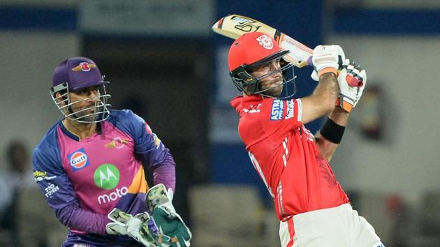 Kings XI Punjab batsman Glenn Maxwell goes for a pull as Rising Pune Supergiants wicketkeeper MS Dhoni looks on during their Indian Premier League match at the Holkar Stadium in Indore on Saturday.(AFP)