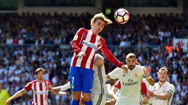 Atletico Madrid's Antoine Griezmann heads the ball during their La Liga match against Real Madrid at the Santiago Bernabeu in Madrid on Saturday. (AFP) Atletico Madrid's Antoine Griezmann heads the ball during their La Liga match against Real Madrid at the Santiago Bernabeu in Madrid on Saturday. (AFP)