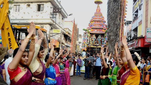 Devotees performing during the annual Panguni celebrations of the Mylapore Sri Kapaleeswarar Temple when a chariot carrying the idol of Lord Shiva is taken out. (PTI)