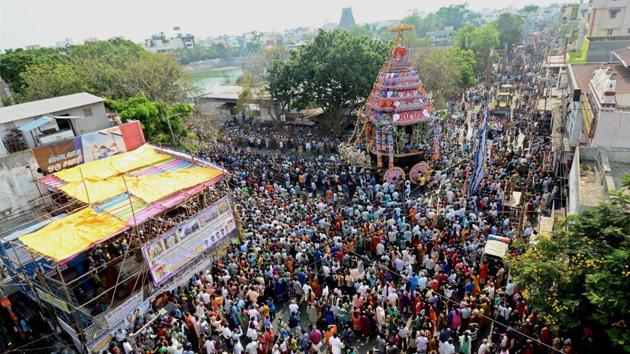 Devotees pull the chariot carrying the idol of Lord Shiva as part of the annual Panguni celebrations of the Sri Kapaleeswarar Temple, in Chennai. (PTI)