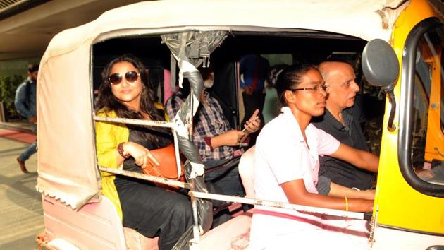 Actress Vidya Balan along with film director and producer Mahesh Bhatt rides a pink auto rickshaw during their visit to state capital for the film "Begum Jaan" in Ranchi on Friday(HT Photo)
