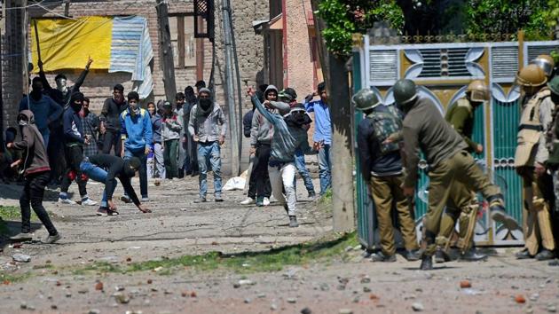 Youths throw stones on Security forces during clashes in Srinagar on Sunday. Four civilians where killed and more than two dozens were injured during the clashes.(PTI Photo)