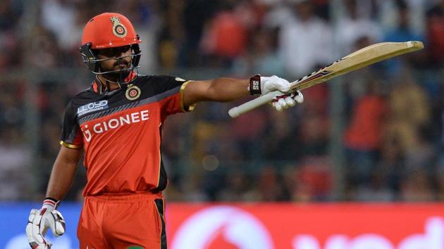 Royal Challengers Bangalore batsman Kedar Jadhav raises his bat after his fifty. (AFP)