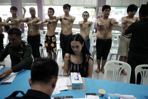 A transgender sits as she waits for her documents during an army draft held at a school in Klong Toey, the dockside slum area in Bangkok, Thailand, April 5, 2017. (Athit Perawongmetha / REUTERS)