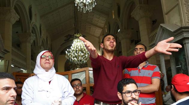 People react at the site of a bomb blast which struck worshippers gathering to celebrate Palm Sunday at the Mar Girgis Coptic Church in the Nile Delta City of Tanta, 120 kilometres (75 miles) north of Cairo, on April 9, 2017. (AFP)