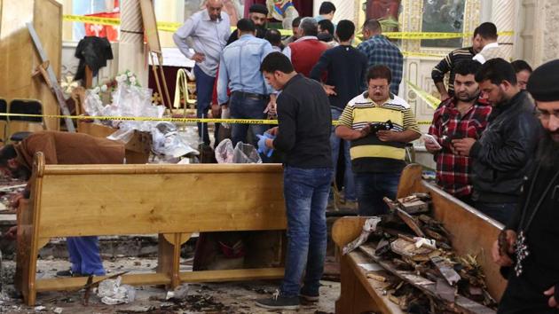 A general view shows forensics collecting evidence at the site of a bomb blast which struck worshippers gathering to celebrate Palm Sunday. (AFP)