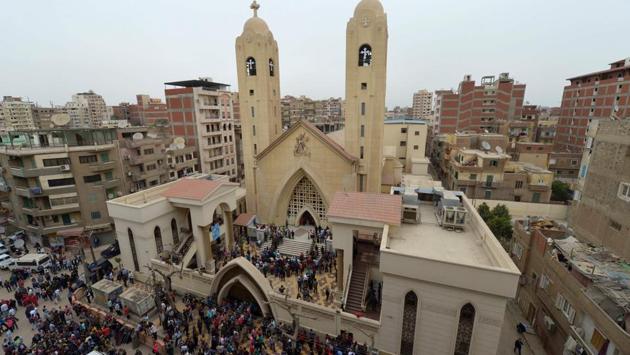 A general view shows people gathering outside the Mar Girgis Coptic Church in the Nile Delta City of Tanta, 120 kilometres (75 miles) north of Cairo, after a bomb blast struck worshippers gathering to celebrate Palm Sunday. (KHALED DESOUKI / AFP)