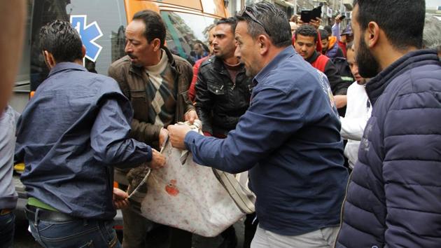 Egyptians try to help ambulance to carry body of victims after a suicide bombing in front of a church in Alexandria, Egypt. (Fawzy Abdel Hamied / REUTERS)
