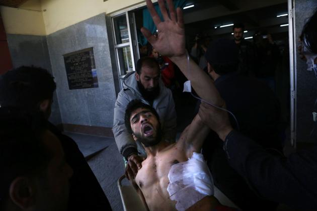 An injured man shouts anti India slogans outside a hospital in Srinagar, Indian. (Mukhtar Khan /AP)