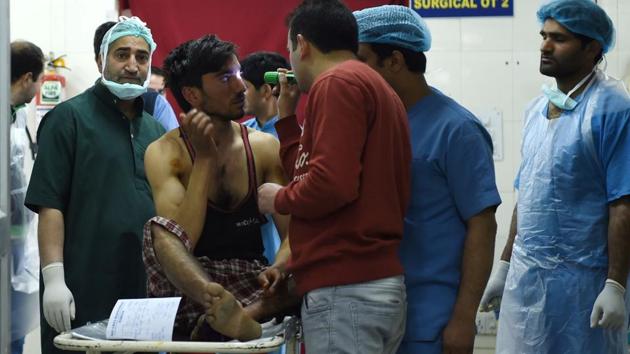A Kashmiri youth injured by a pellet gun is examined by medical staff in a ward at a hospital in Srinagar on Sunday.(AFP Photo)