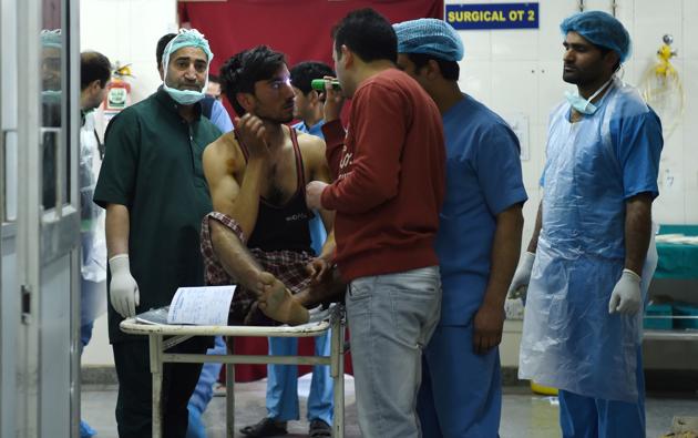 An injured being examined by medical staff in a ward at a hospital in Srinagar. The violence in the other districts was reported despite stringent security arrangements across the Valley. (Tauseef MUSTAFA / AFP)