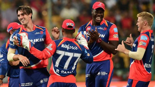 Delhi Daredevils pacer Pat Cummins with teammates celebrate the wicket of Mandeep Singh. (PTI)