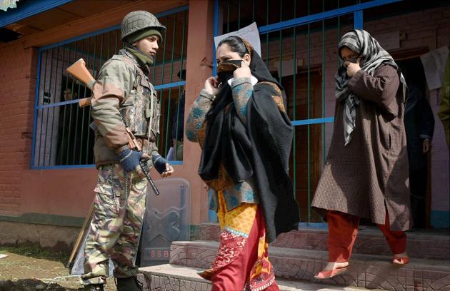 Women come out from a polling station after casting their vote for Srinagar Parliamentary constituency of Jammu and Kashmir at Budgam in Srinagar on Sunday. (S Irfa / PTI)