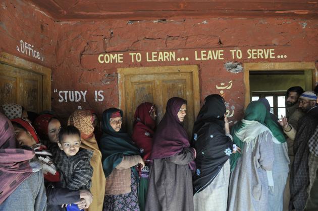 Women stand in a queue as they wait to cast their vote outside a polling station in Baba Nagri area in Kangan, some 50 km from Srinagar. (Waseem Andrabi / Ht photo)