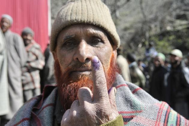 Member of Gujjar community shows his ink marked finger after casting vote, outside a polling station in Baba Nagri area in Kangan, some 50 km from Srinagar.