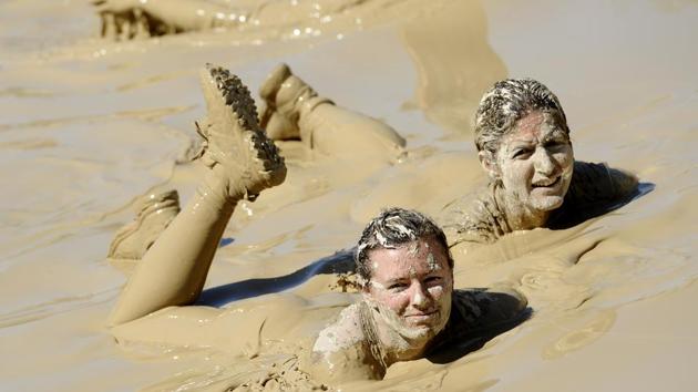 Runners take part in the Mud Day, a 13km race with obstacles, on April 8, 2016, at the Lac de Peyrolles, near Aix en Provence, southern France. (Franck PENNANT / AFP)