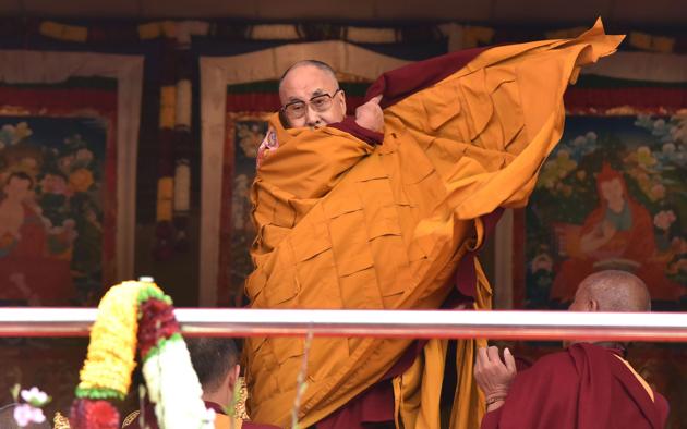 Exiled Tibetan spiritual leader the Dalai Lama adjusts his shawl as he came to deliver his religious teaching at Yiga Choezin ground at in Tawang District near India-china border in India's north-eastern state of Arunachal Pradesh state, on April 8, 2017. The Dalai Lama on April 8, 2017 addressed devotees at the monastery near India's border with China where he took shelter on his flight from Tibet, drawing protests from Beijing which claims the Himalayan area as its territory. (Biju BORO / AFP)