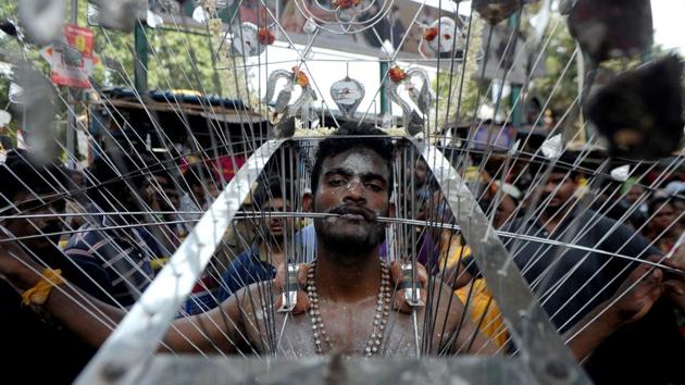 An Indian Hindu devotee, his body pierced with metal skewers, takes part in a procession to mark the Panguni Uthiram festival in Chennai on April 9, 2017. (ARUN SANKAR / AFP)