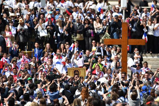 The name Palm Sunday comes from the palm branches that people laid down in Jesus’ path as he rode into Jerusalem on the donkey. (Alberto PIZZOLI / AFP)