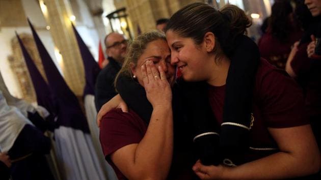 Costaleras (women who carry a float bearing the statue of Christ) of the Santo Cristo de la Sangre brotherhood get emotional as they get ready to take part in a procession during the Holy Week in Medina Sidonia, southern Spain. (Susana Vera/REUTERS)