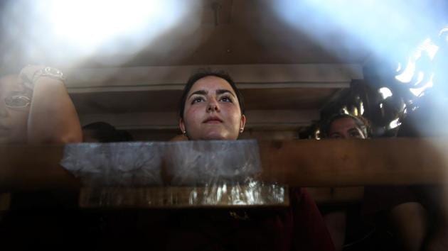 Costaleras (women who carry a float bearing the statue of Christ) of the Santo Cristo de la Sangre brotherhood take part in a procession during the Holy Week in southern Spain. (Susana Vera/REUTERS)