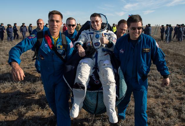 Ground personnel carry International Space Station (ISS) crew member and NASA astronaut Shane Kimbrough shortly after the landing of Russia's Soyuz MS-02 space capsule near the town of Dzhezkazgan (Zhezkazgan), Kazakhstan. Three space fliers have safely touched down on Earth after almost six months aboard the International Space Station. (Bill Ingalls/NASA / REUTERS)