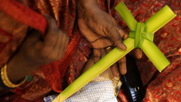An Indian Christian worshipper holds a cross made from palm leaves during a Palm Sunday Mass in Chennai. (Arun Sankar/AFP)