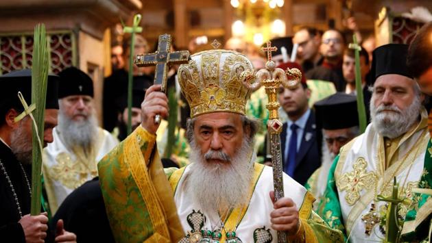 Greek Orthodox Patriarch of Jerusalem Theophilos III (C) leads the Palm Sunday Easter procession at the Church of the Holy Sepulchre in Jerusalem's Old City. (Gali Tibbon/AFP)
