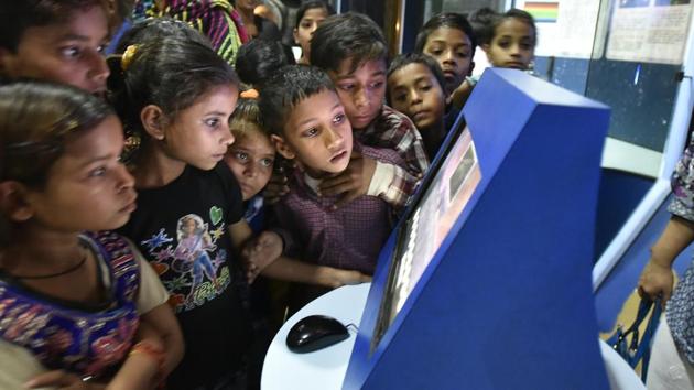Children look at an interactive touch screen at the digital information gallery of Nehru Planetarium. (Raj K Raj/HT PHOTO)