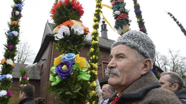 Faithful carry handmade palms during a procession in the village of Glinianka, Poland. (Alik Keplicz/AP)