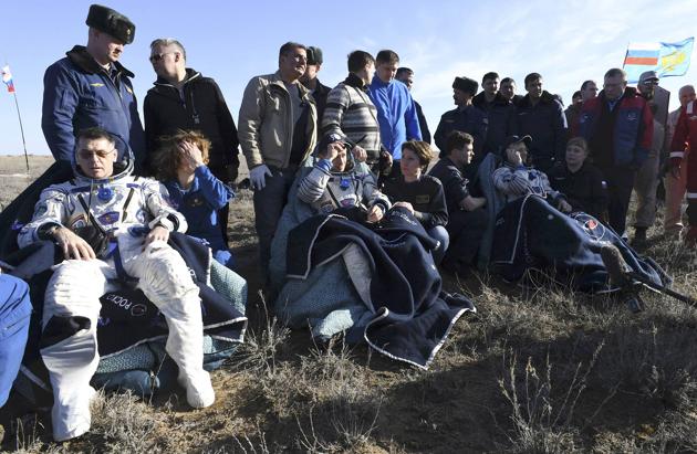 NASA astronaut Shane Kimbrough (left) and Russian cosmonauts Sergey Ryzhikov (center) and Andrey Borisenko (right) are seen seated shortly after landing their Soyuz spacecraft (Kirill Kudryavtsev/Pool / REUTERS)