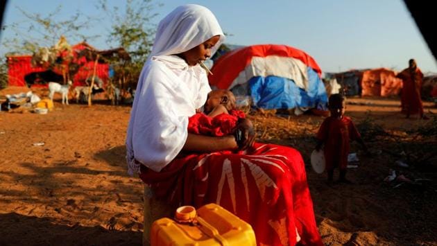 Zeinab, 14, sits as she holds her nephew at a camp for internally displaced people from drought hit areas in Dollow, Somalia. Last year, an older man offered $1,000 for her dowry, enough to take her extended family to Dollow, a Somali town on the Ethiopian border where international aid agencies are handing out food and water to families fleeing a devastating drought. Zeinab refused. (Zohra Bensemra/REUTERS)