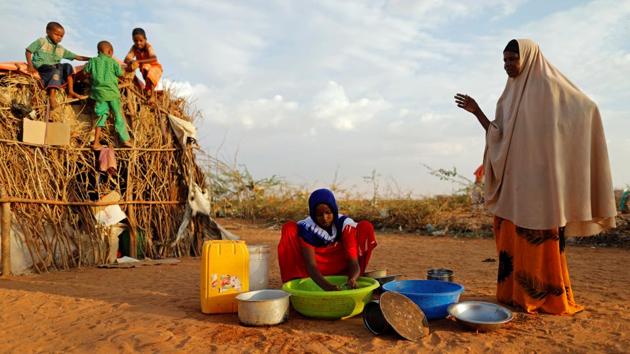 Zeinab, 14, (C) washes dishes as her mother Abdir Hussein gestures and her nephews play. It extends from the red soil of Nigeria in the west, where Boko Haram’s six-year jihadist insurgency has forced 2 million people to flee their homes, to Yemen’s white deserts in the east, where warring factions block aid while children starve. (Zohra Bensemra/REUTERS)