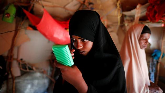 Zeinab, 14, applies her make-up before heading to school. As U.S. President Donald Trump threatens to slash aid budgets, the United Nations says the drought and conflicts in the four countries are fuelling humanity’s greatest collective disaster since World War Two. (Zohra Bensemra/REUTERS)