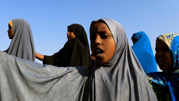 Zeinab, 14, (Rear C) stands in a daily morning queue to recite verses of the Koran and national songs before the beginning of class at the school. Missing from the statistics are the heart-wrenching choices families make every day to survive. (Zohra Bensemra/REUTERS)