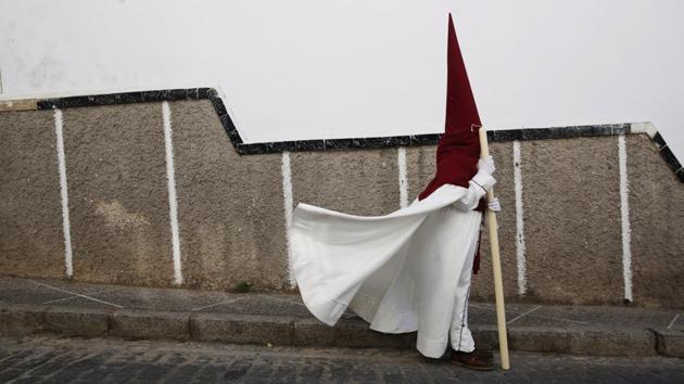 A penitent of the Santo Cristo de la Sangre brotherhood takes part in a procession during the Holy Week in Medina Sidonia, southern Spain. (Susana Vera/REUTERS)