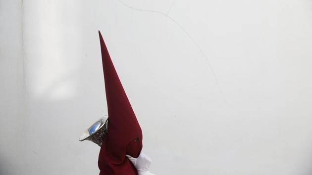 A penitent of the Santo Cristo de la Sangre brotherhood takes part in a procession during the Holy Week in Medina Sidonia, southern Spain. (Susana Vera/REUTERS)