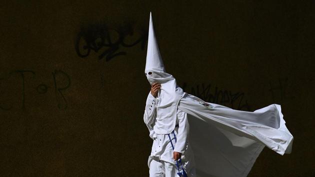 A penitent of the 'La Paz' brotherhood walks during the Holy Week. (Cristina Quicler/AFP)